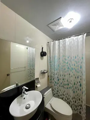 a bathroom with a sink and a toilet and a shower at Tropical unit in Manila