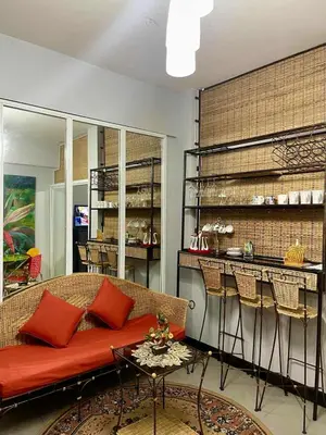 a living room with a couch and a bar at Tropical unit in Manila