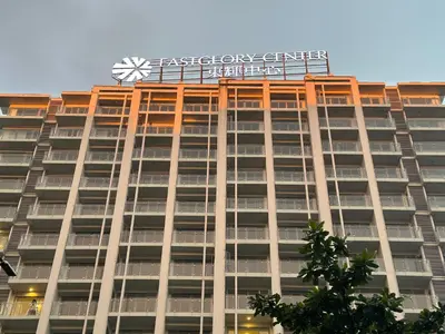 a building with a sign on top of it at Spacious 2BR Apartment Hotel near City of Dreams, Airport, MOA, Okada, Ayala Malls, and Solaire Casino with free 5 pool access in Manila