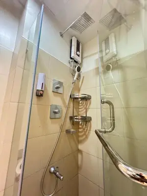 a shower in a bathroom with a glass door at The Horizon Suite by Crib2GO in Manila
