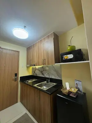 a small kitchen with a sink and a microwave at The Horizon Suite by Crib2GO in Manila