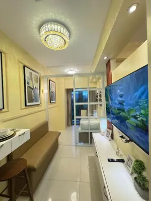 a living room with a large fish tank on the wall at The Horizon Suite by Crib2GO in Manila