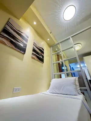 a bedroom with a white bed and a window at The Horizon Suite by Crib2GO in Manila