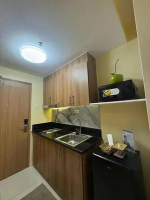 a small kitchen with a sink and a microwave at The Horizon Suite by Crib2GO in Manila