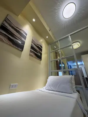 a bedroom with a bed and a window at The Horizon Suite by Crib2GO in Manila