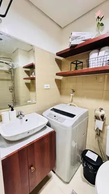 a bathroom with a sink and a toilet at GreySky Studio in Manila