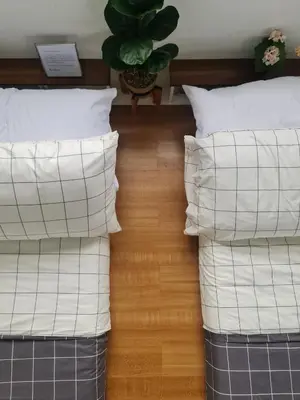 two stacks of pillows on a bed with a plant at The Zentuary - House with pool in Amadeo