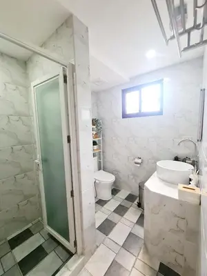 a bathroom with a shower and a sink and a toilet at The Zentuary - House with pool in Amadeo