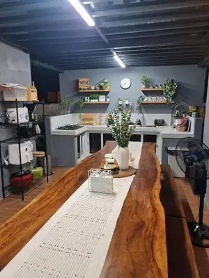 a large kitchen with a wooden table in a room at The Zentuary - House with pool in Amadeo