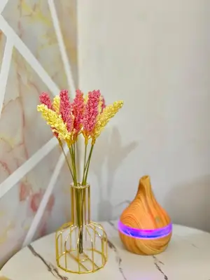 two vases with flowers sitting on a table at Azure Parañaque, 1BR Bahamas 15th floor in Manila