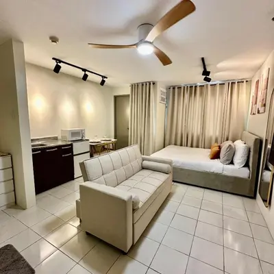 a living room with a bed and a couch at ComfyCondo near Enchanted Kingdom in Santa Rosa