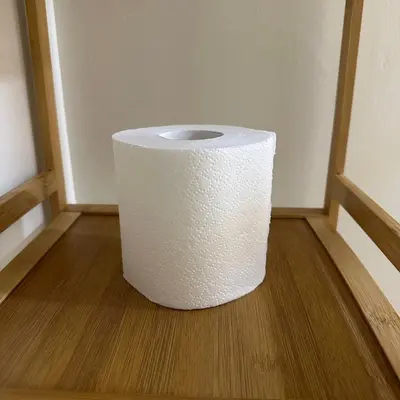 a roll of toilet paper sitting on a wooden floor at ComfyCondo near Enchanted Kingdom in Santa Rosa
