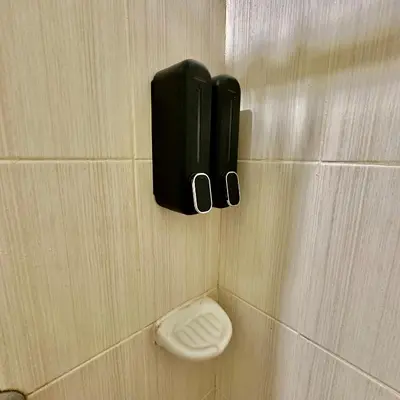 a bathroom stall with a toilet in a wall at ComfyCondo near Enchanted Kingdom in Santa Rosa