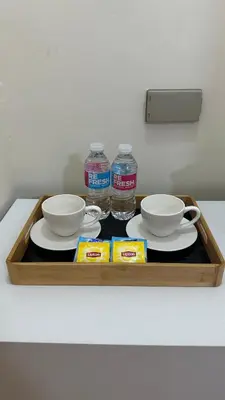 a tray with two bowls and two bottles of water at ComfyCondo near Enchanted Kingdom in Santa Rosa
