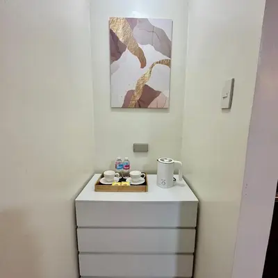 a white cabinet with a tray on top of it at ComfyCondo near Enchanted Kingdom in Santa Rosa