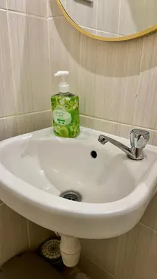 a bathroom sink with a bottle of soap on it at ComfyCondo near Enchanted Kingdom in Santa Rosa