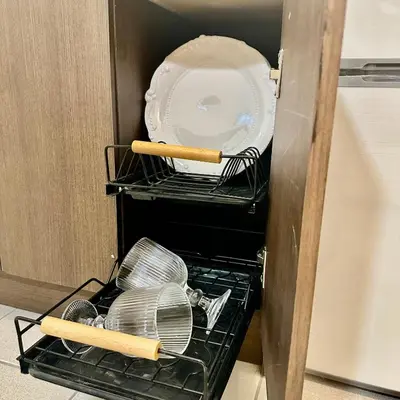 a drawer filled with plates and utensils in a refrigerator at ComfyCondo near Enchanted Kingdom in Santa Rosa