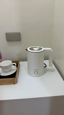 a slow cooker sitting on a counter next to a bowl at ComfyCondo near Enchanted Kingdom in Santa Rosa