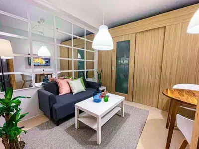 a living room with a couch and a table at Wowstaycation in Manila