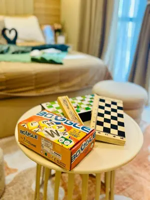 a table with boxes of cereal and a chess game on it at Staycation in viceroy mckinley near venice grand canal in Manila