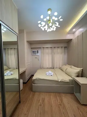 a bedroom with two beds and a mirror at Radiance manila bay in Manila