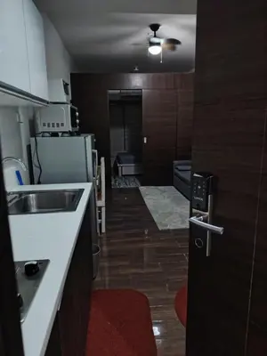 a small kitchen with a sink and a refrigerator at 1 Bedroom Cozy and Relaxing Place in Manila