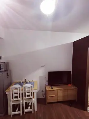 a room with a table and two stools and a tv at 1 Bedroom Cozy and Relaxing Place in Manila