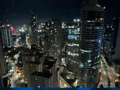 a view of a city at night with many tall buildings at 1 Bedroom Cozy and Relaxing Place in Manila