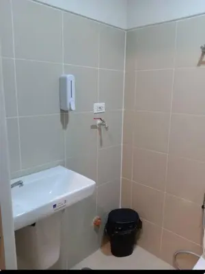 a bathroom with a sink and a shower at 1 Bedroom unit in Fame Residence in Manila