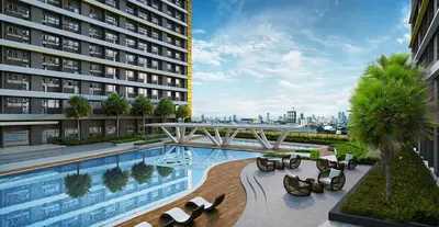 a hotel with a swimming pool and a building at 1 Bedroom unit in Fame Residence in Manila