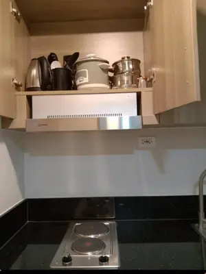 a kitchen with a stove and some pots and pans at 1 Bedroom unit in Fame Residence in Manila