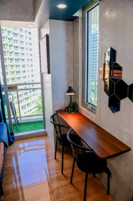 a dining room with a table and chairs and a large window at Azure Urban Resort Staycation 2 bedrooms beach view, 9th floor in Manila