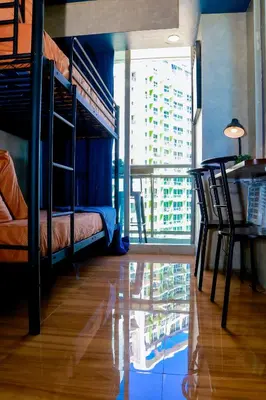 a bedroom with bunk beds and a table and a desk at Azure Urban Resort Staycation 2 bedrooms beach view, 9th floor in Manila