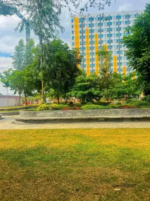 a park with a large building in the background at Jungle Hostel 1062 in Manila