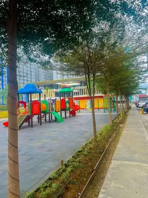 a playground with colorful play equipment in a park at Jungle Hostel 1062 in Manila