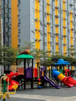 a playground with different colored slides in a park at Jungle Hostel 1062 in Manila