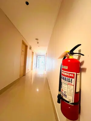 a fire extinguisher on the wall of a room at Sea Residence MOA - Paul Condotel in Manila