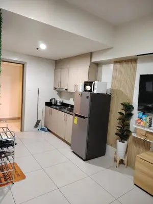 a kitchen with a refrigerator in a room at Affordable Breeze Residence unit 2118 in Manila