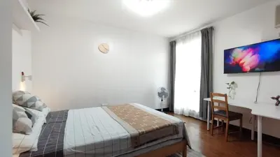 a bedroom with a bed and a desk and a computer at Delet TEA in Manila