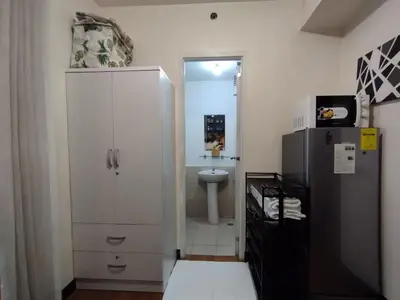 a small bathroom with a toilet and a sink at Delet TEA in Manila