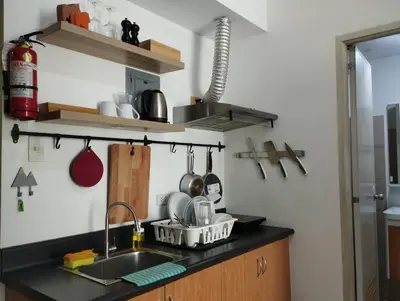 a kitchen with a sink and a counter with utensils at Delet TEA in Manila