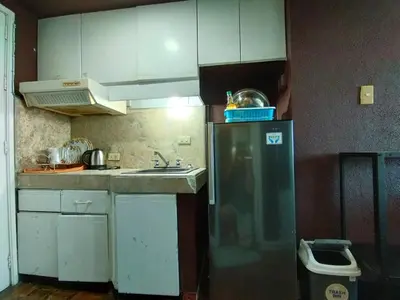 a kitchen with a sink and a refrigerator at Delet CITADEL in Manila
