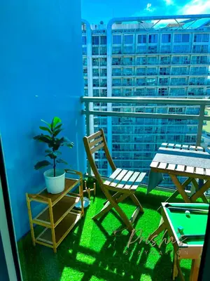 a patio with a table and chairs on a balcony at Prisha Staycation in Manila