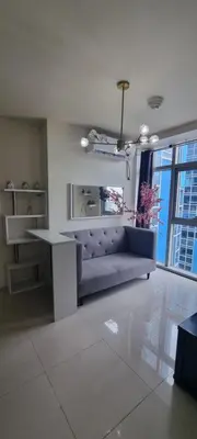 a living room with a couch and a table at Rikki Staycation in Manila