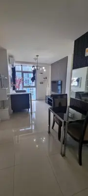 a living room with a couch and a table at Rikki Staycation in Manila