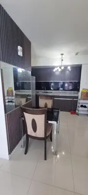 a room with a bench and a table and a cross at Rikki Staycation in Manila