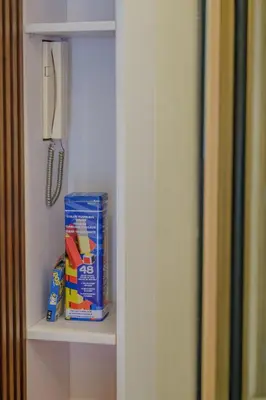a cabinet with a box of milk and a knife at Coasis at SMDC Coast Residences in Manila