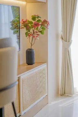 a plant in a vase sitting on top of a television at Coasis at SMDC Coast Residences in Manila