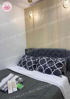 a bedroom with a bed with a black and white blanket at Shore 2 Tower 1 - Macy's Nest - Near MOA in Manila