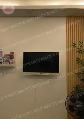 a flat screen tv hanging on a wall at Shore 2 Tower 1 - Macy's Nest - Near MOA in Manila